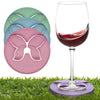 Wine Glass Slipper Holder Stabilizer in multicolors with four colorful circular silicone disc-shaped wine glass stabilizers on grass, featuring a glass of red wine using one stabilizer to prevent tipping—a perfect outdoor wine glass accessory for summer picnics